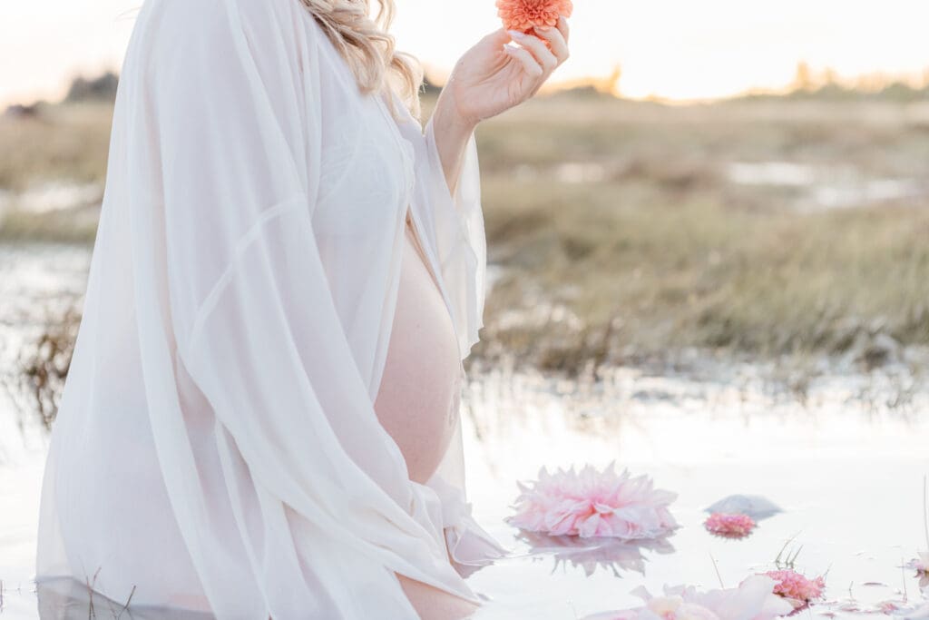 Close-up of a neutral maternity dress showing soft fabric and natural textures