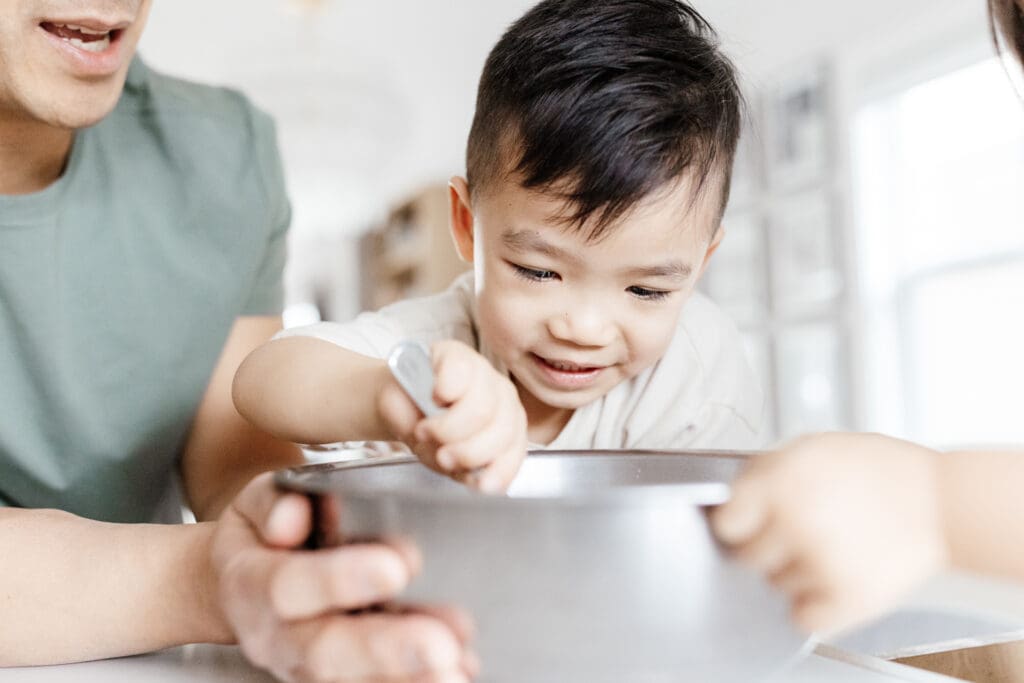 Close-up of a young boy stirring ingredients during a baking moment.