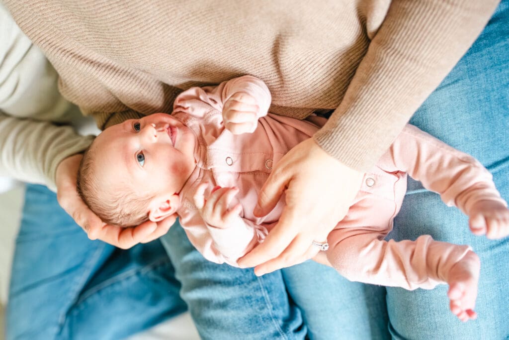 Close-up of parent and child wearing neutral textures that photograph well indoors