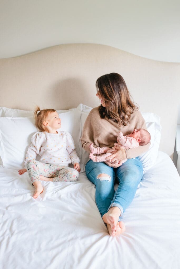 Family wearing light, neutral outfits for an in-home lifestyle photography session