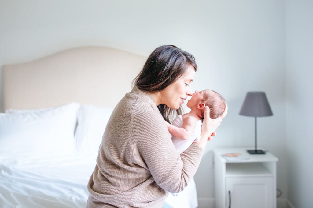 In-home family photo showing neutral outfits that work well for lifestyle family photography