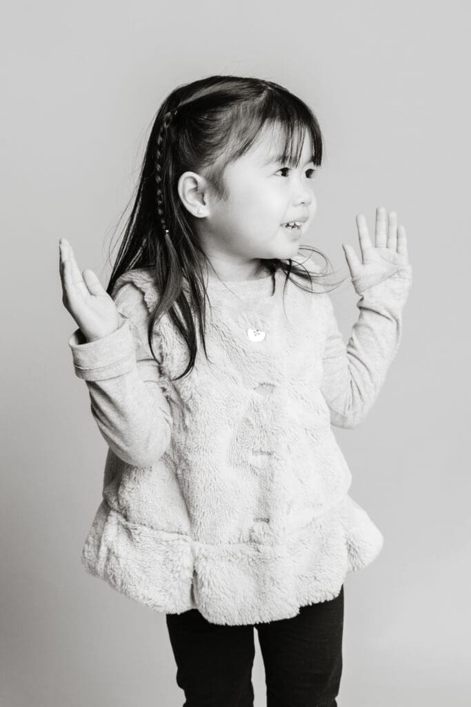 Black and white daycare portrait of playful child