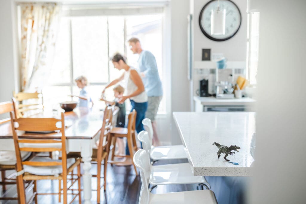 documentary-style in-home family photography with a dinosaur in the foreground
