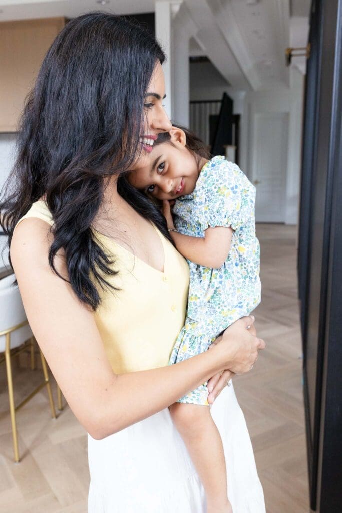 Mother holding her child in kitchen during an in-home family photography session in Vancouver.
