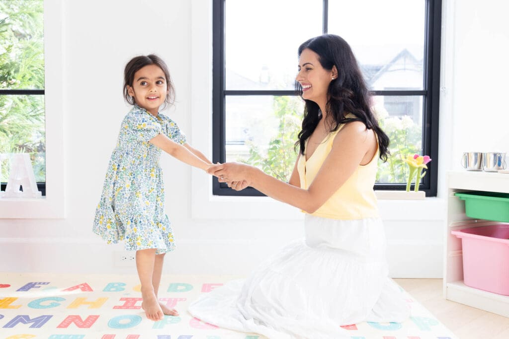 Mother playing with her child near a window during an in-home family photography session in Vancouver.