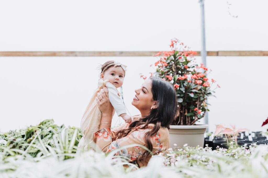 Mom lifting her toddler during a joyful family photography session in Vancouver