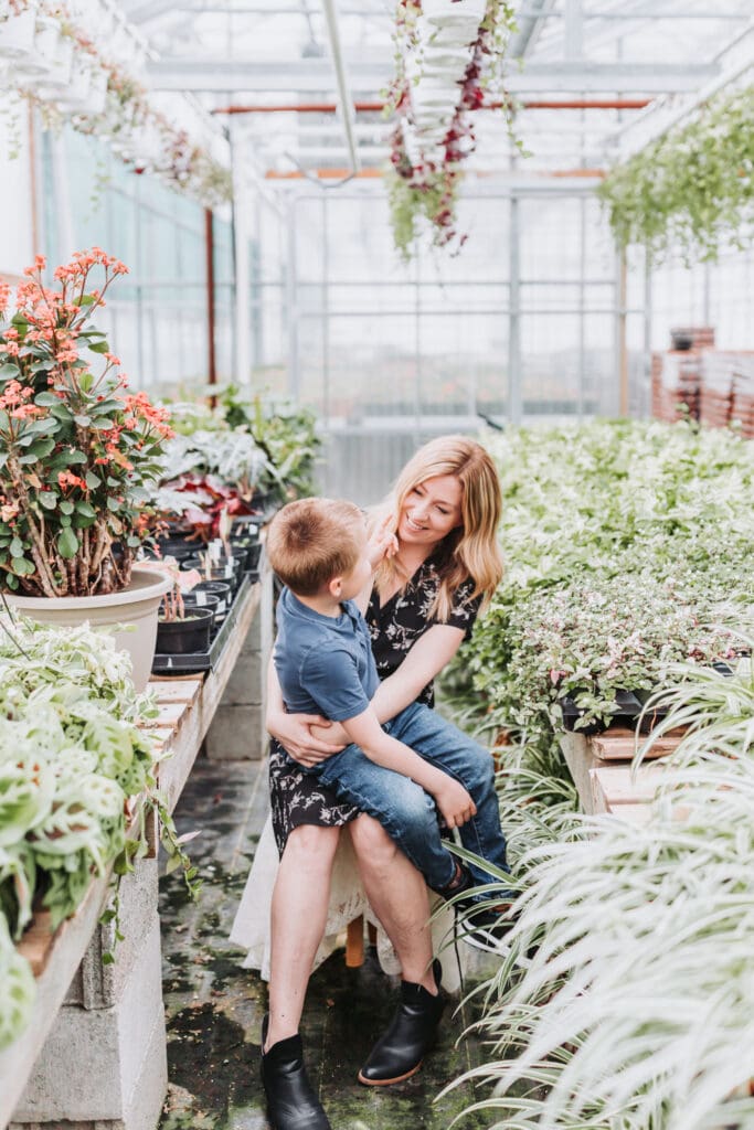 Soft, natural family photos of mom and son captured in a greenhouse setting in British Columbia