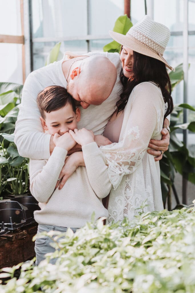 family of three in a garden centre family photo session in Vancouver