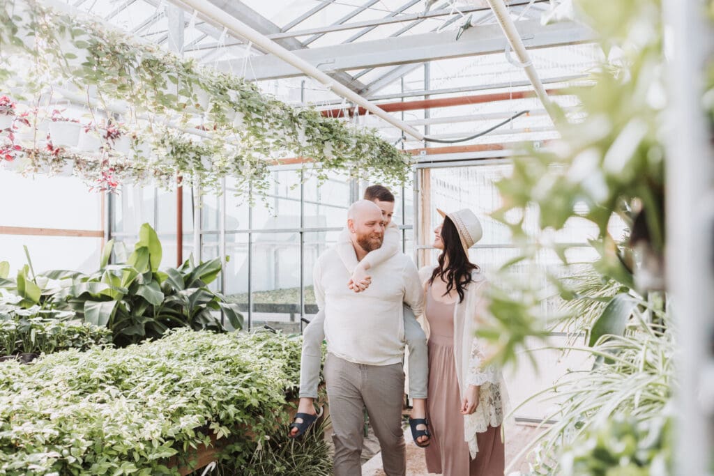family of three in a garden centre family photo session in Vancouver greehouse