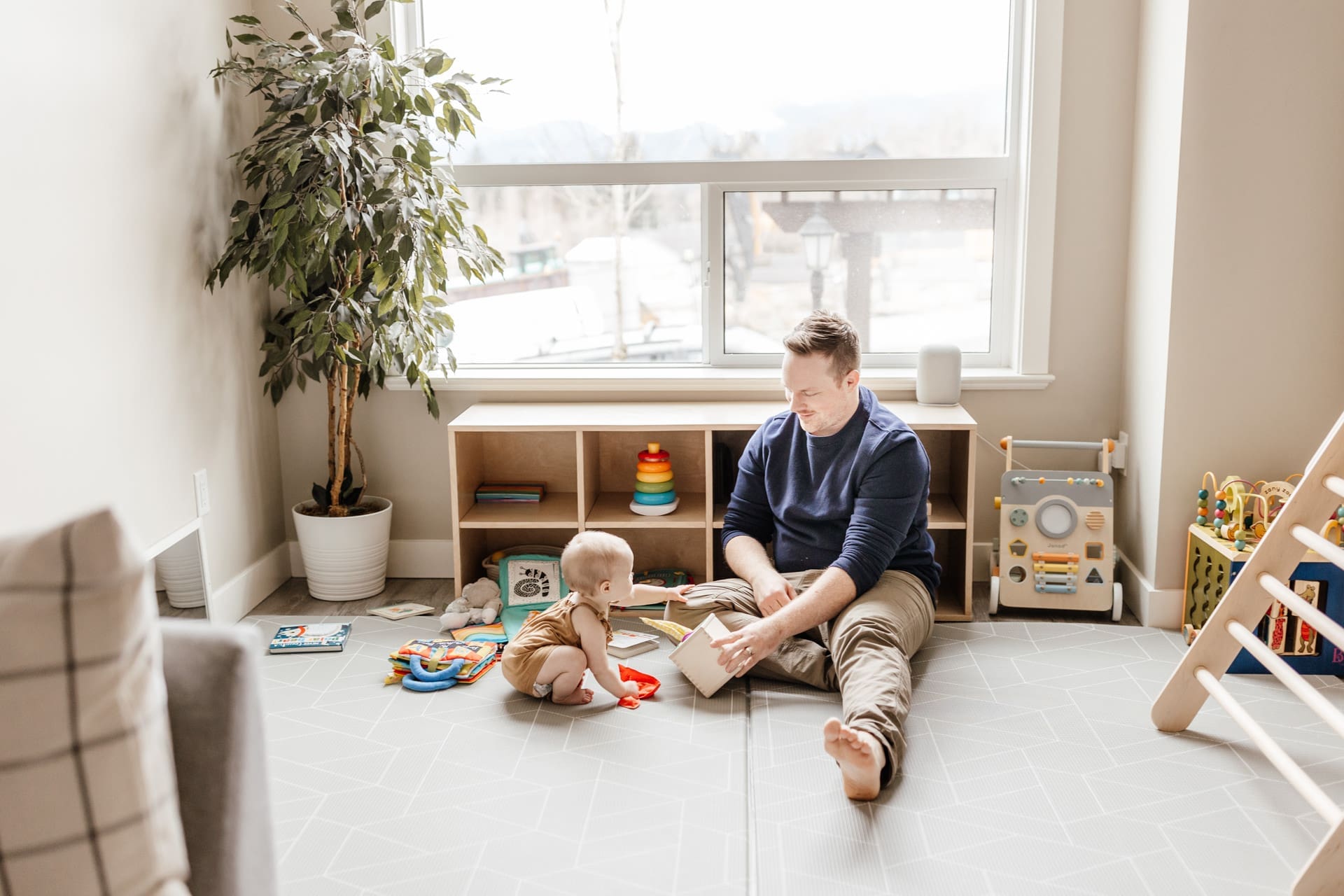 father and daughter in living room playing with toys during a quiet lifestyle family photo session