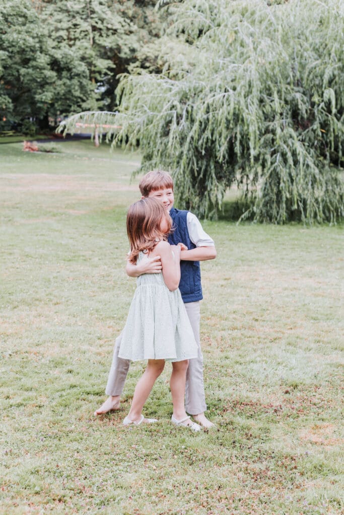 Brother and sister playing together at the Stanley Park Rose Garden in Vancouver
