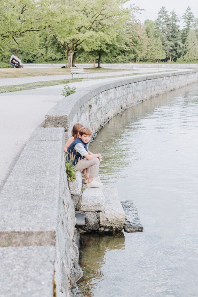 Children exploring the shoreline along the Stanley Park Seawall
