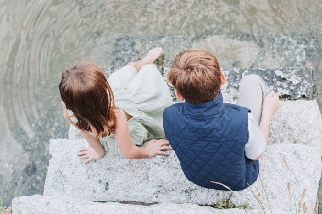 Brother and sister looking for sea life along the Stanley Park Seawall