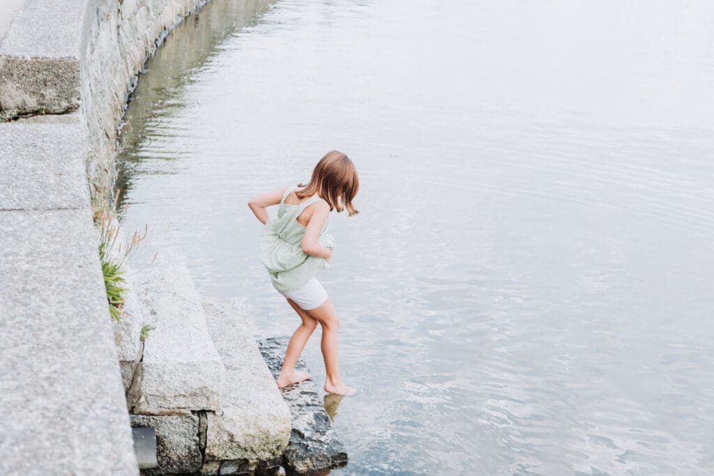 sister looking for sea life along the Stanley Park Seawall