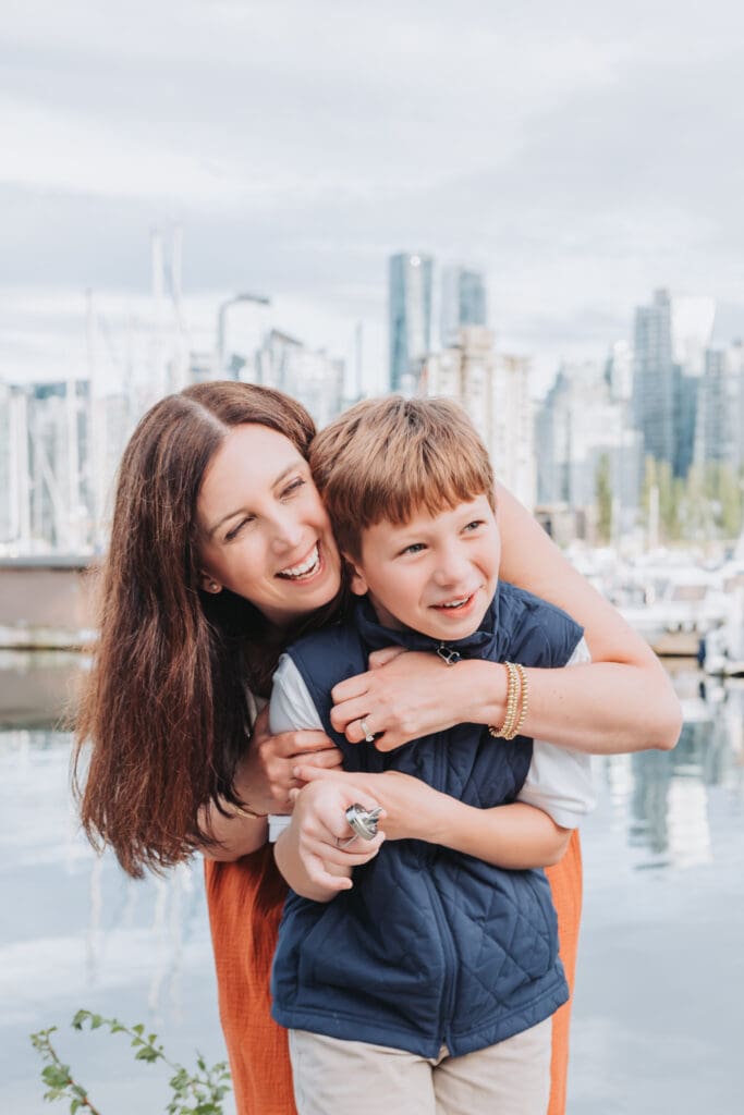 Candid family vacation photo of mother and son along the Stanley Park Seawall