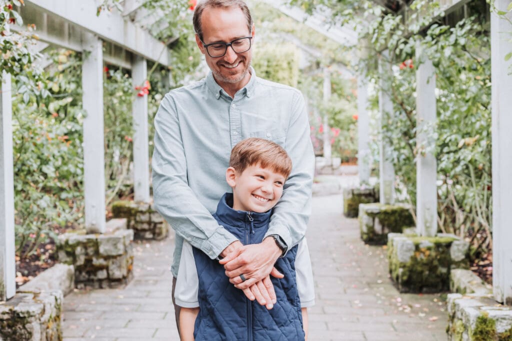Father and son sharing a moment at the Stanley Park Rose Garden in Vancouver