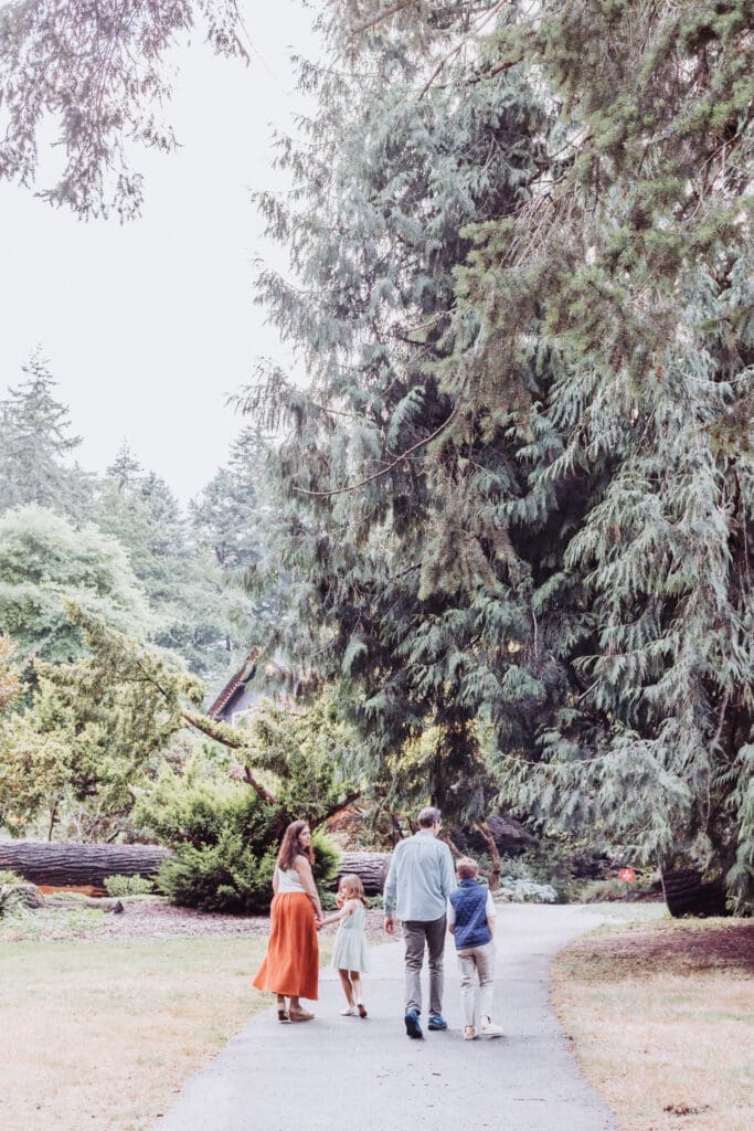 Family of four in the gardens at Stanley Park Pavilion in Vancouver