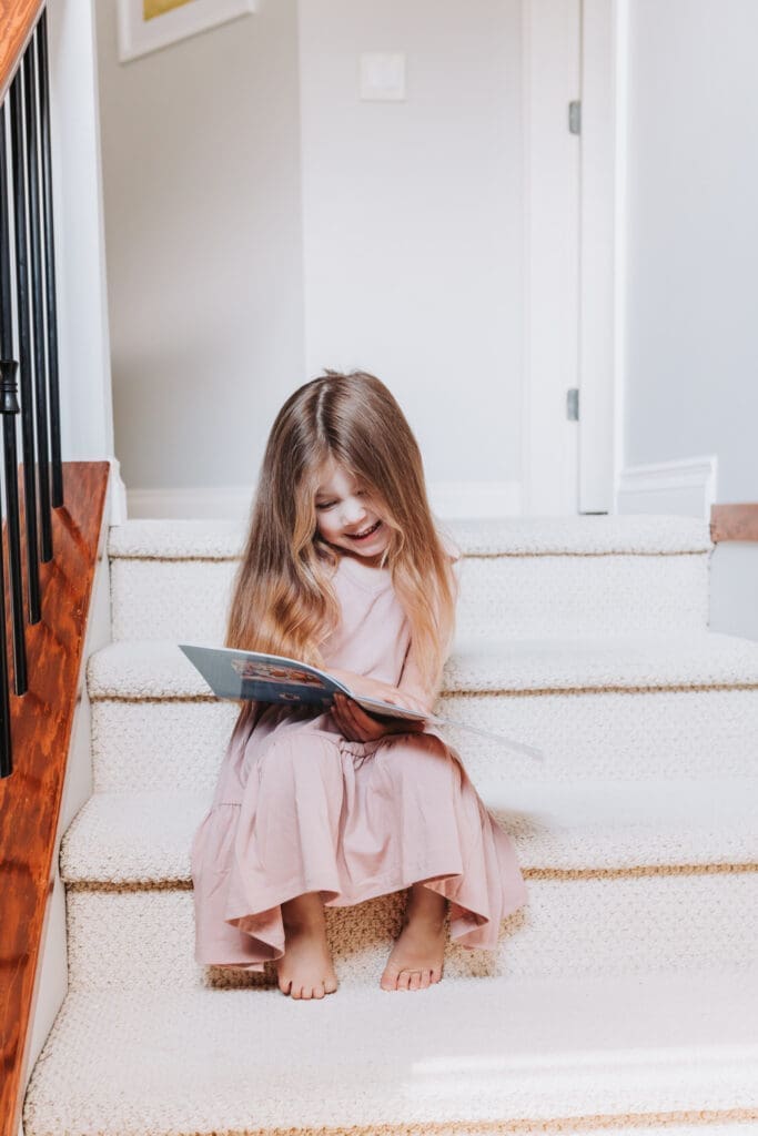 toddler reading during an in-home newborn session